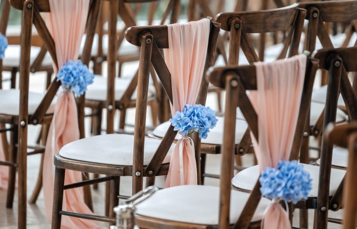wedding venue chairs with blue flowers